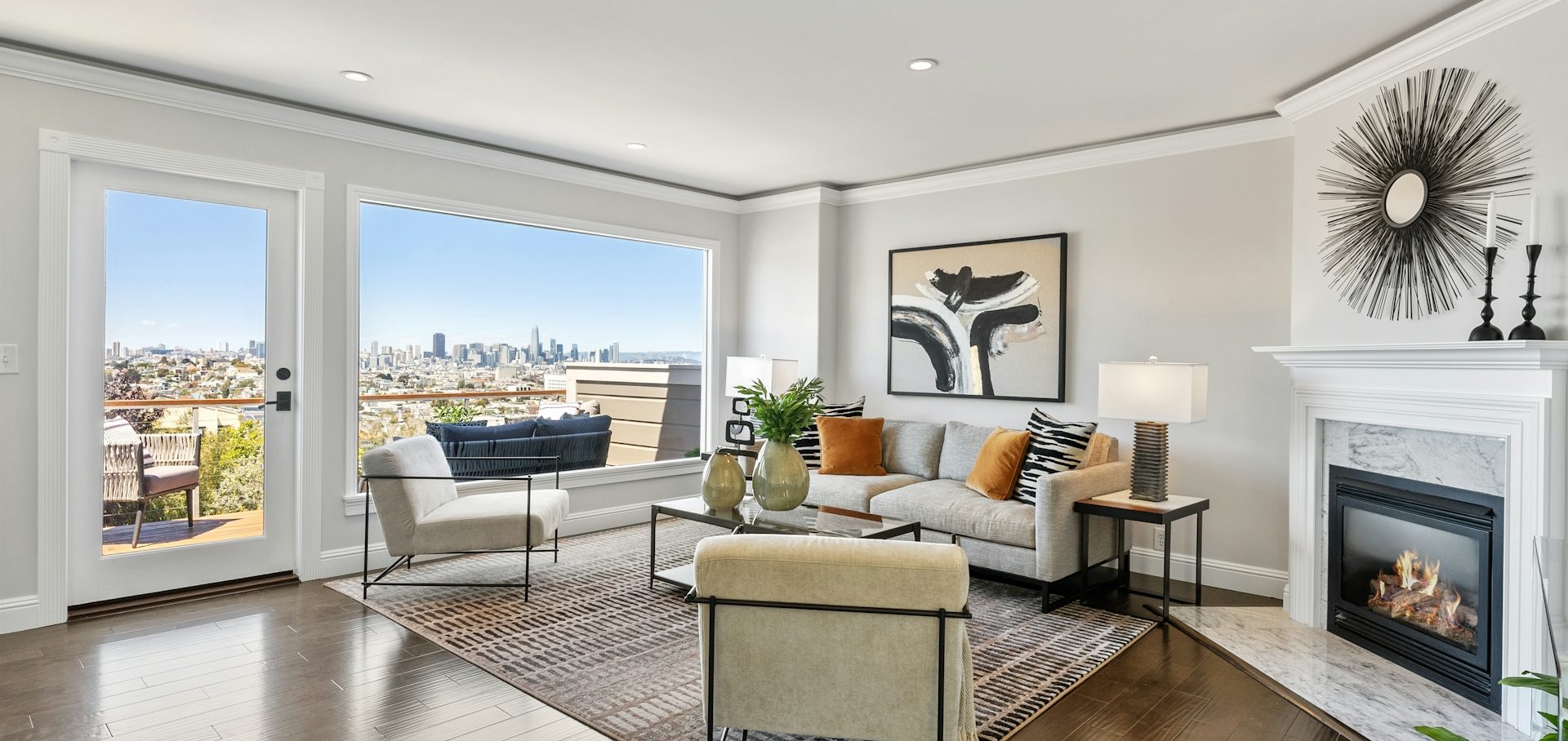 Modern living room with large windows, city view, and stylish furniture accents.
